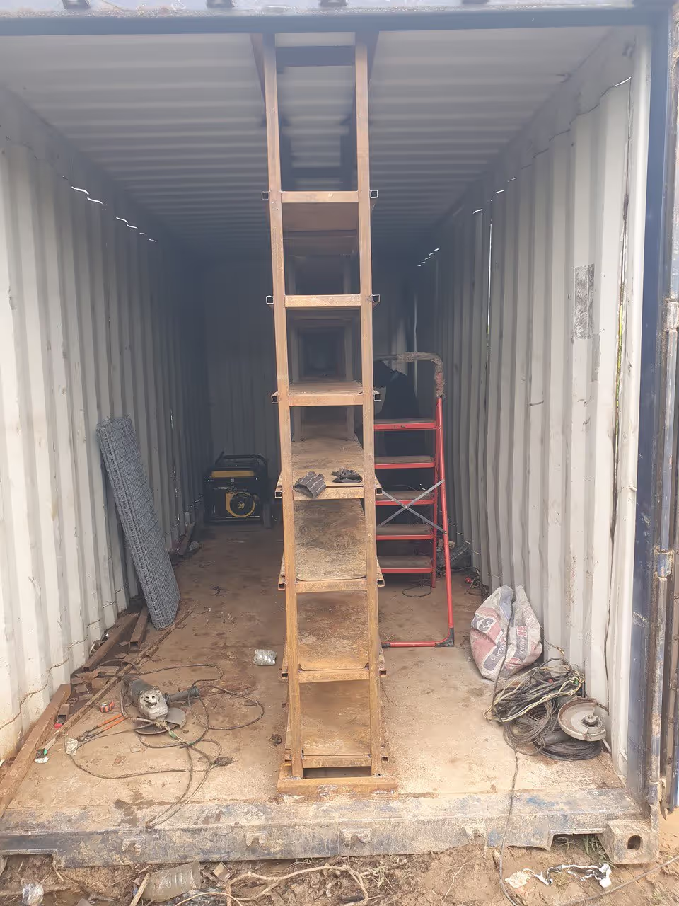 Our shipping container being transformed into a mining container. The rack where the ASICs will reside installed in the middle.